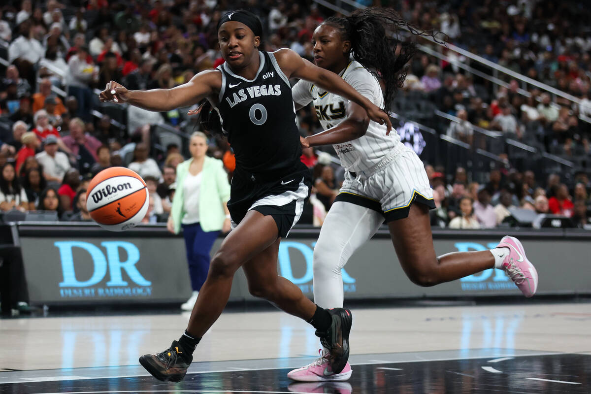 Las Vegas Aces guard Jackie Young (0) reaches for a loose ball against Chicago Sky forward Mich ...