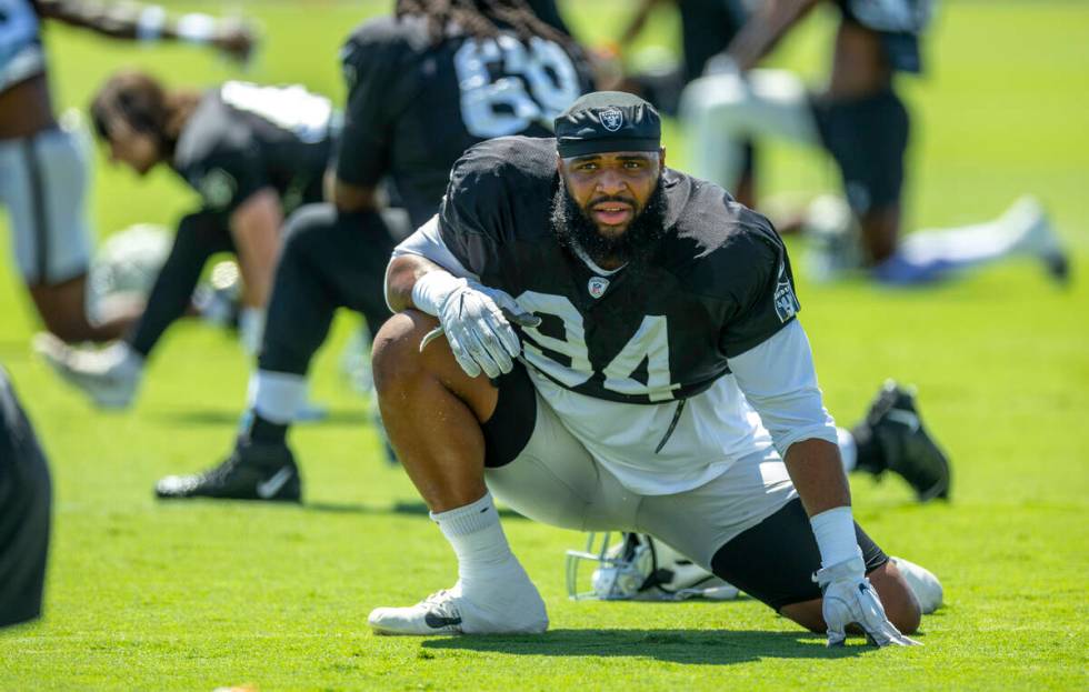 Raiders defensive tackle Christian Wilkins (94) stretches with teammates during practice at the ...