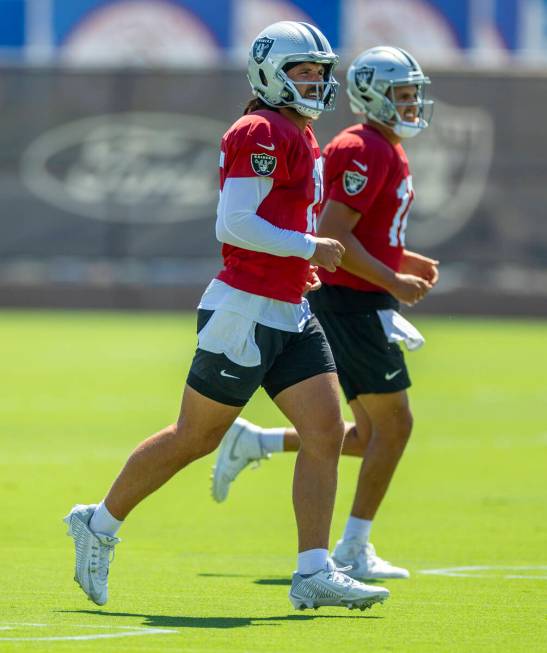 Raiders quarterback Gardner Minshew (15) with quarterback Aidan O'Connell (12) run over to a dr ...