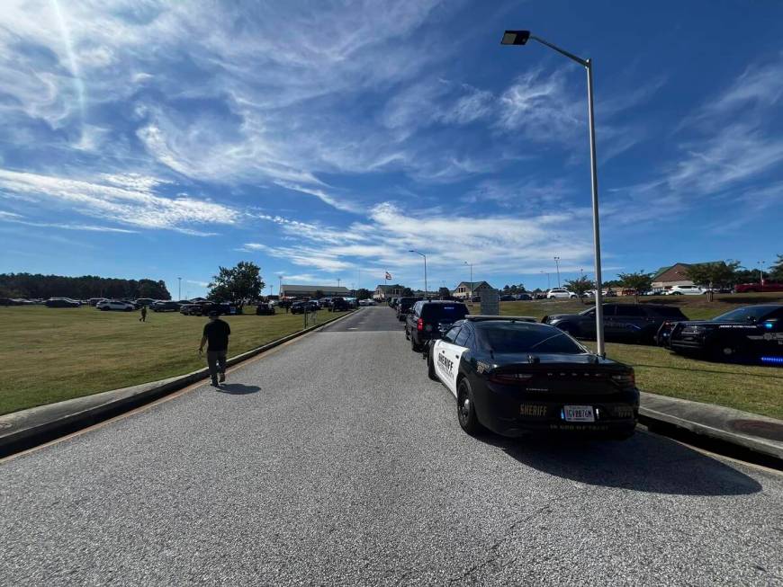 Law enforcement arrive as students are evacuated to the football stadium after the school campu ...