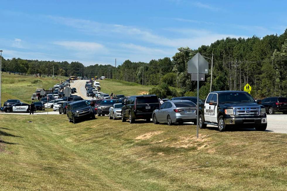 Law enforcement arrive as students are evacuated to the football stadium after the school campu ...