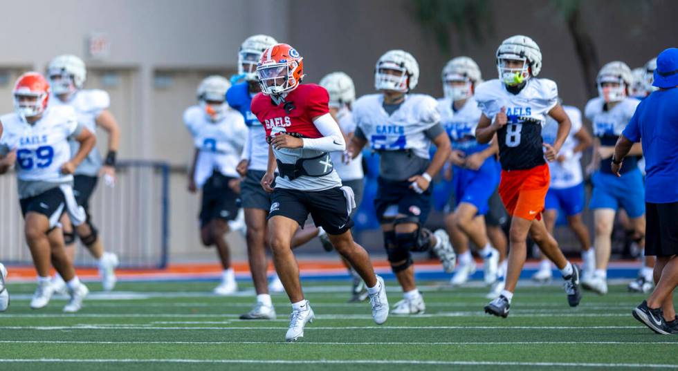 Bishop Gorman quarterback Melvin Spicer IV (#2) runs with teammates during football practice on ...