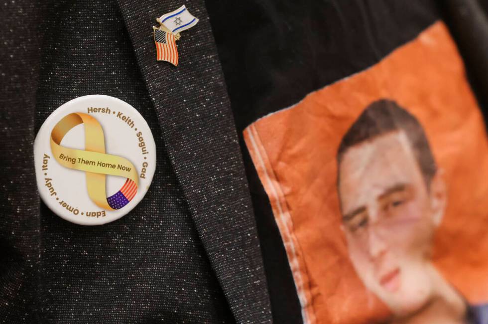 Ronen Neutra wears a button in honor of eight individuals, including his son, Omer, who have be ...