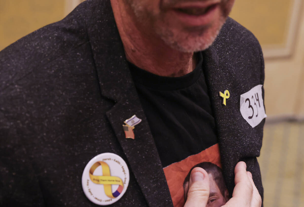 Ronen Neutra wears a sticker with the number 334 on it, representing the amount of days that hi ...