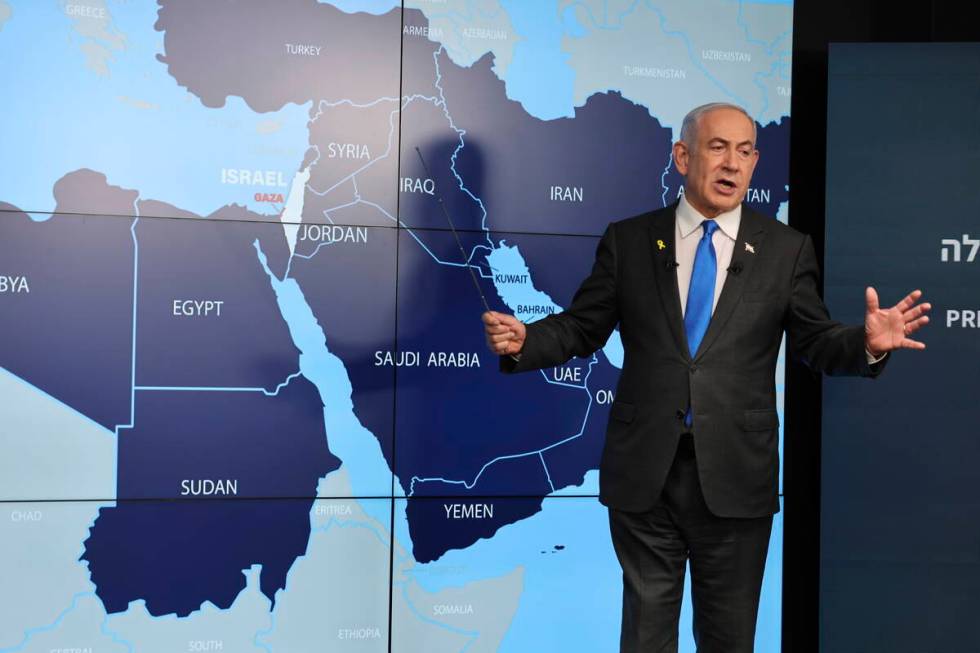 Israeli Prime Minister Benjamin Netanyahu stands before a map during a press conference at the ...