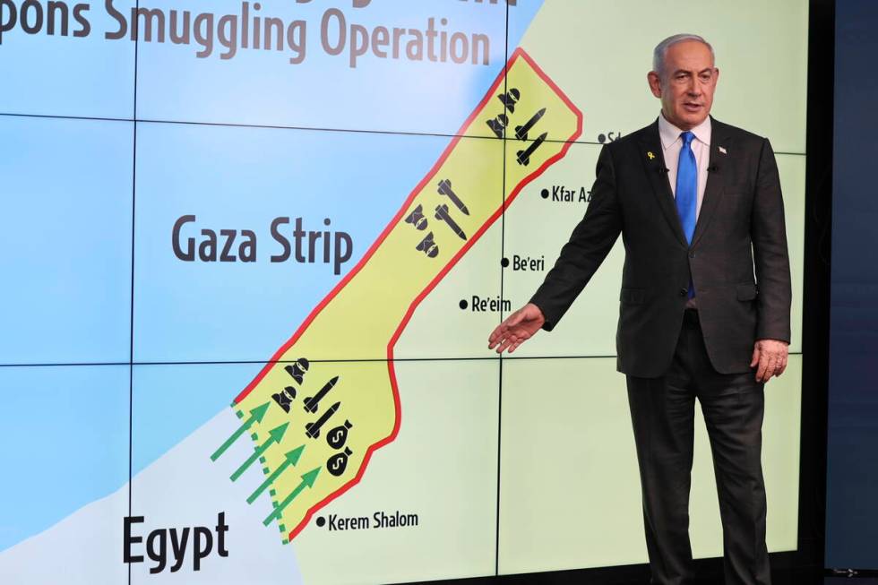 Israeli Prime Minister Benjamin Netanyahu gestures in front of a map during a press conference ...