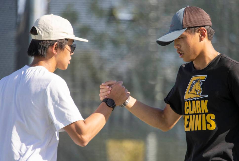 Clark sophomore Tristan Trinh, left, and senior Jayden Hong, right, celebrate during the high s ...