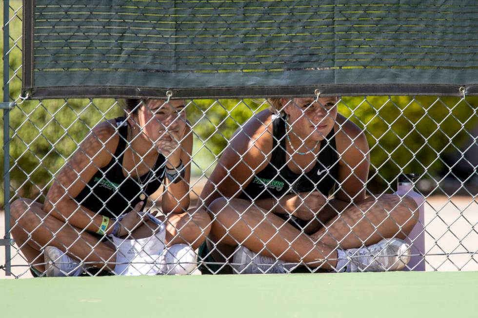 Palo Verde players watch their teammates in the shade during the high school tennis matches aga ...