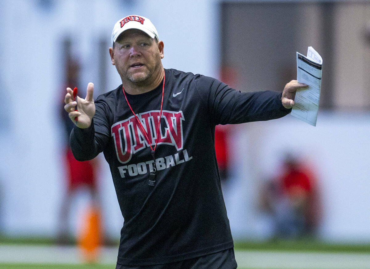 UNLV head coach Barry Odom instructs his players during football practice at the Intermountain ...