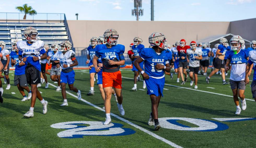 Players run on the field during Bishop Gorman football practice on Tuesday, Sept. 03, 2024, in ...