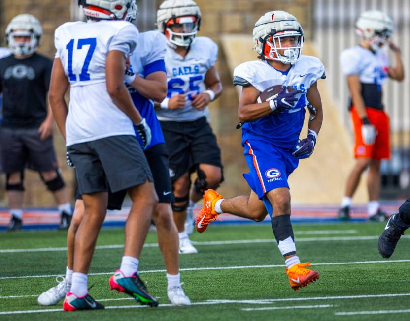 Bishop Gorman running back Myles Norman (24) looks for daylight on a run during football practi ...