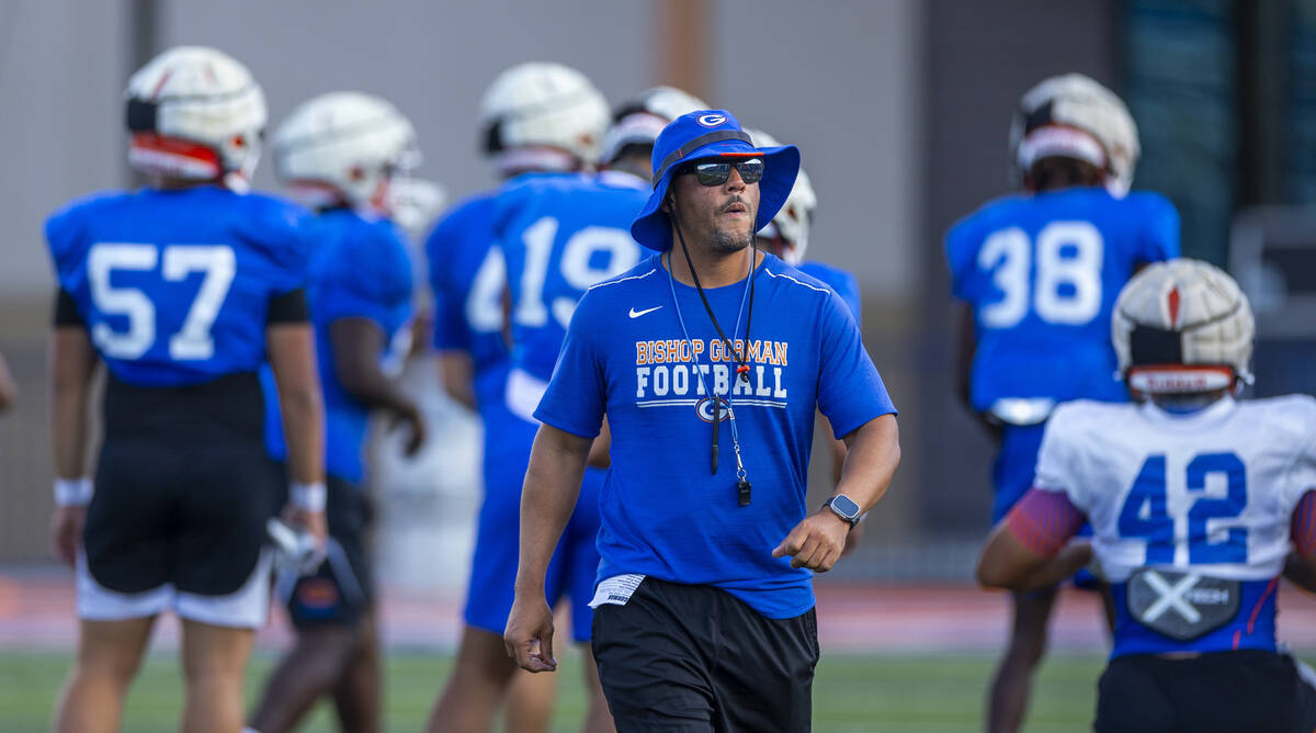 Bishop Gorman head coach Brent Browner walks up the field during football practice on Tuesday, ...