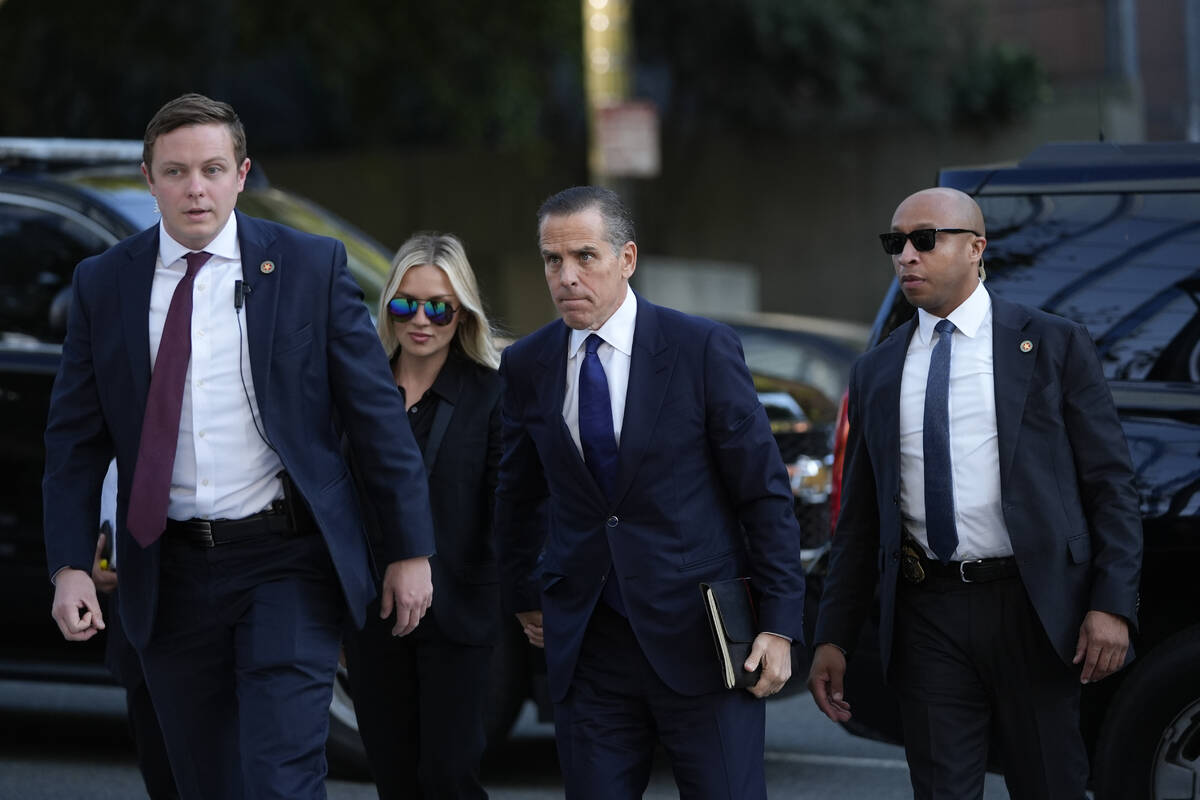 Hunter Biden, center, and his wife, Melissa Cohen Biden, arrive in federal court for jury selec ...