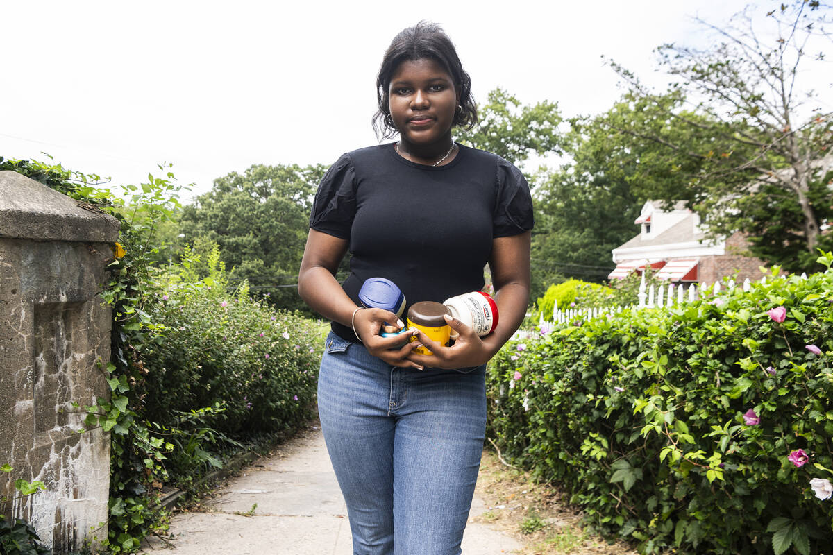 Mia Hall, 14, poses for a portrait in her neighborhood park while holding some skin care produc ...