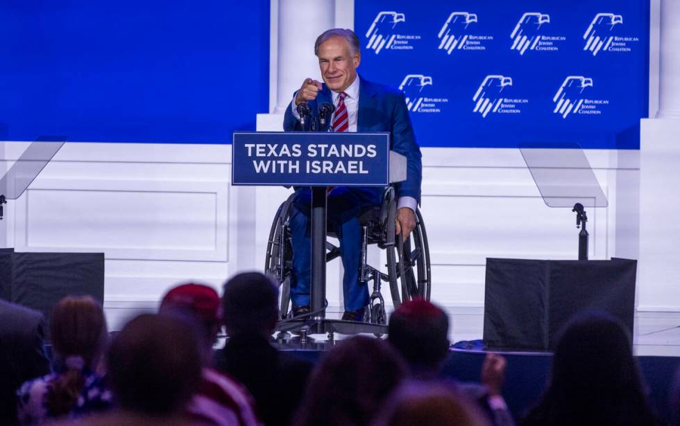 Texas Governor Greg Abbott greets the crowd during the Republican Jewish Coalition’s ann ...