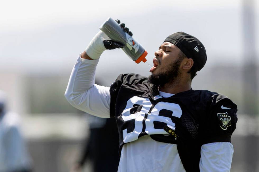 Raiders defensive tackle Jonah Laulu takes a water break during team practice at the Intermount ...