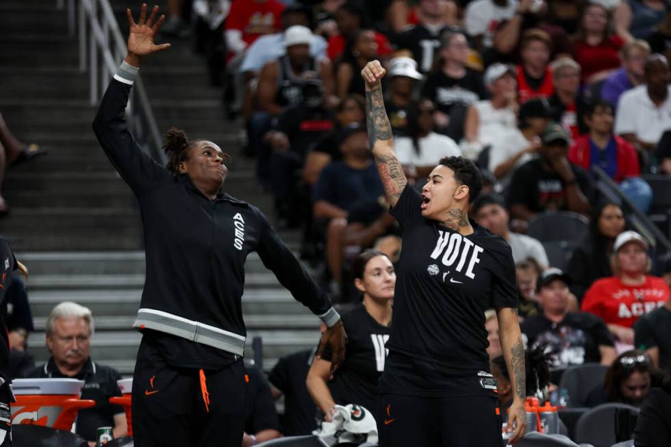 Las Vegas Aces forward Queen Egbo, left, and guard Kierstan Bell (1) imitate an A’ja Wil ...