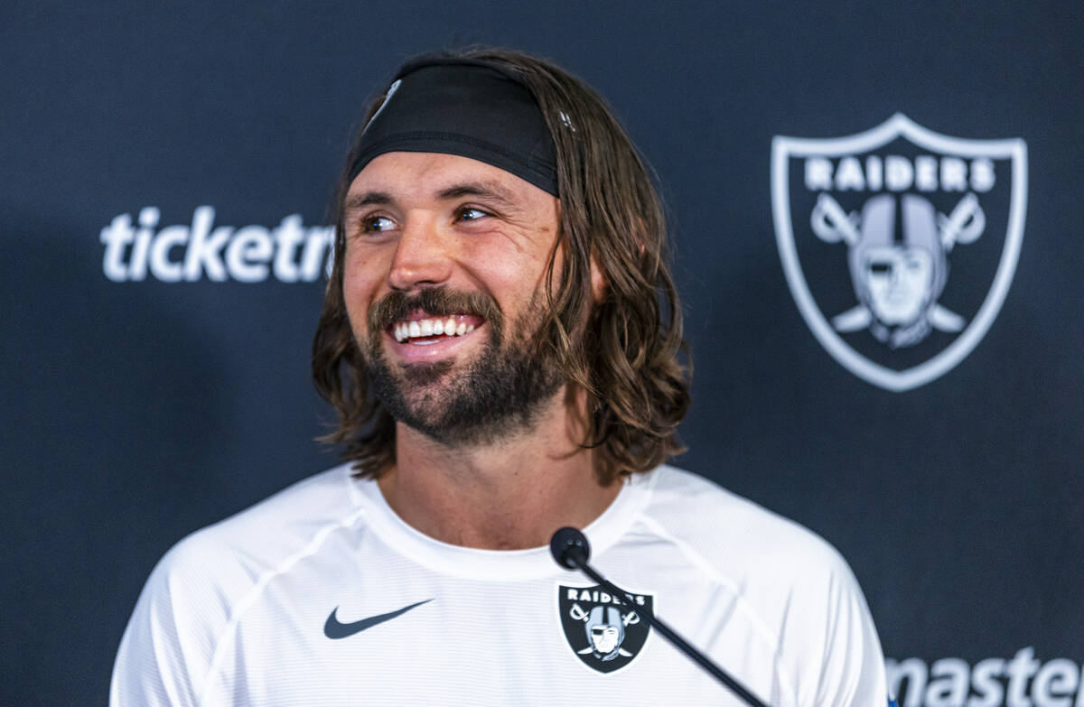 Raiders quarterback Gardner Minshew (15) laughs at a media question after practice at the Inter ...