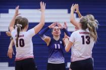 Coronado libero Reagan Vine (11) celebrates an ace with her teammates during a volleyball match ...