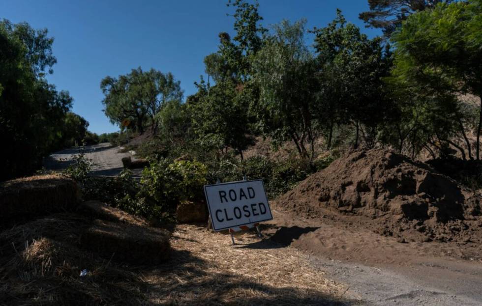 A road closure sign stands in a neighborhood affected by ongoing landslides in Rancho Palos Ver ...