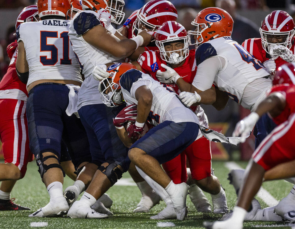 Bishop Gorman running back Myles Norman (24) battles for yards against Mater Dei during the fir ...