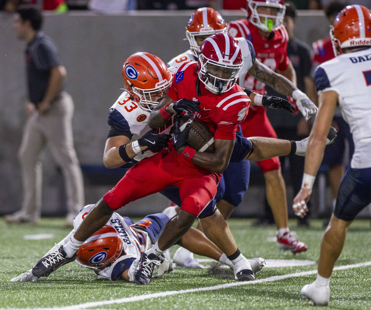 Bishop Gorman defensive lineman Ryan Baalbaky (33) catches Mater Dei wide receiver Kayden Dixon ...