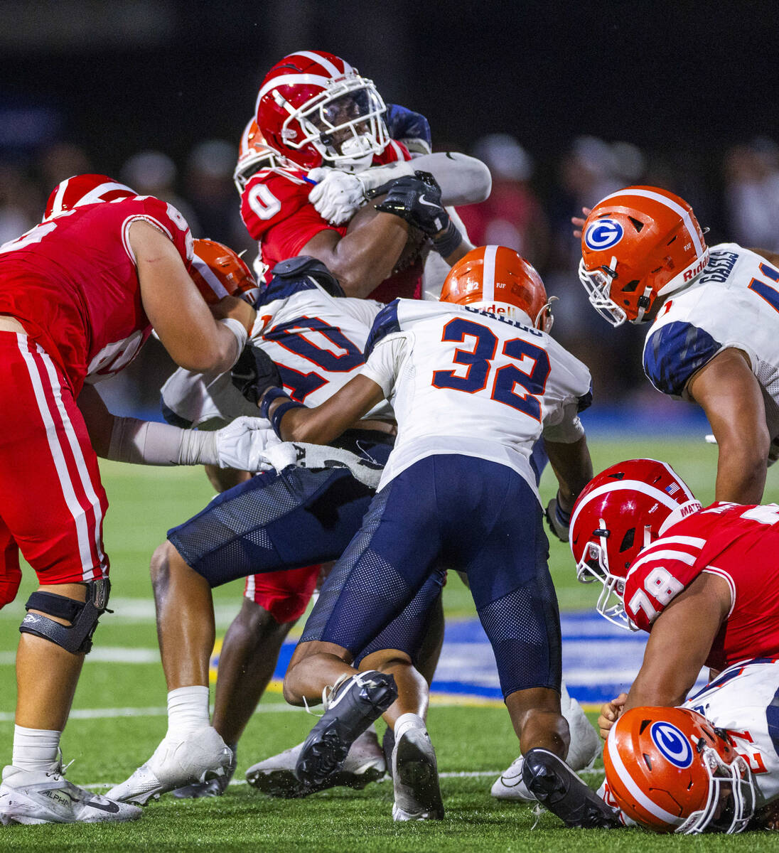 Mater Dei running back Jordon Davison (0) is swarmed by Bishop Gorman linebacker Tamatoa Gaoteo ...