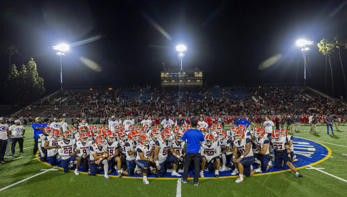 Bishop Gorman head coach Brent Browner and players come together on the field after a loss to M ...