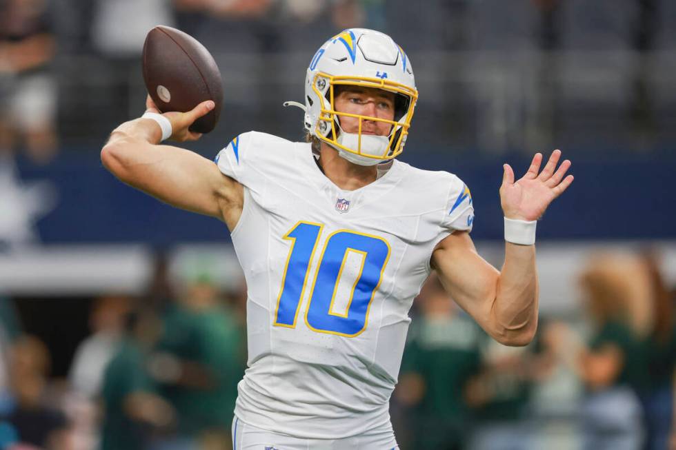 Los Angeles Chargers quarterback Justin Herbert warms up before a preseason NFL football game a ...