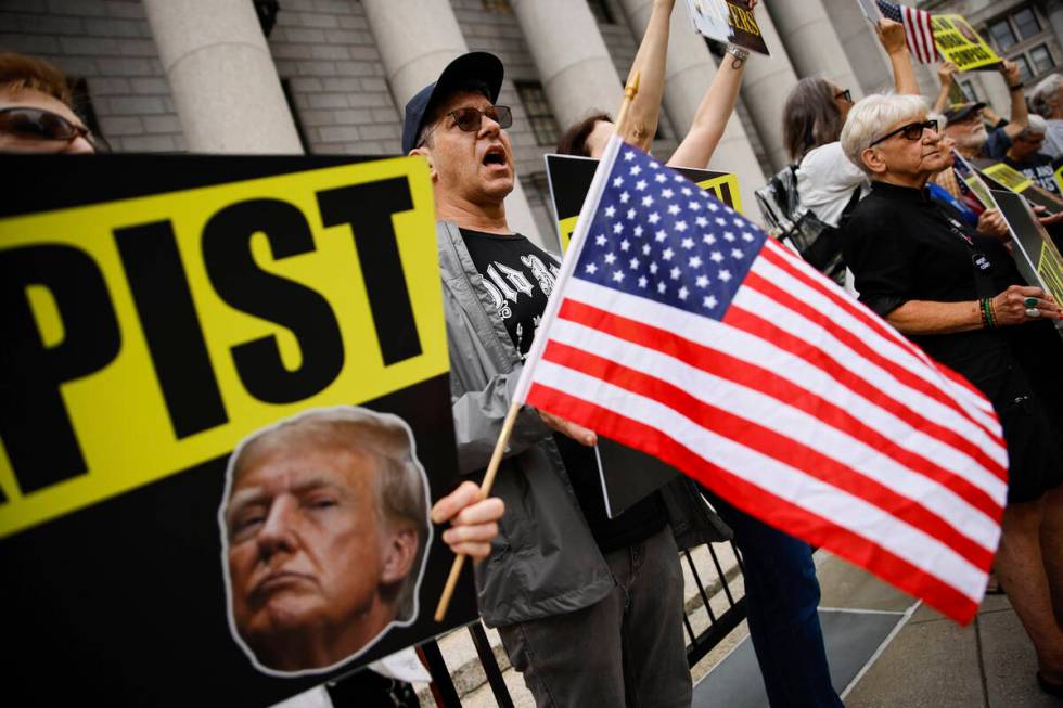 People protest against former President Donald Trump before his arrival to the New York Federal ...