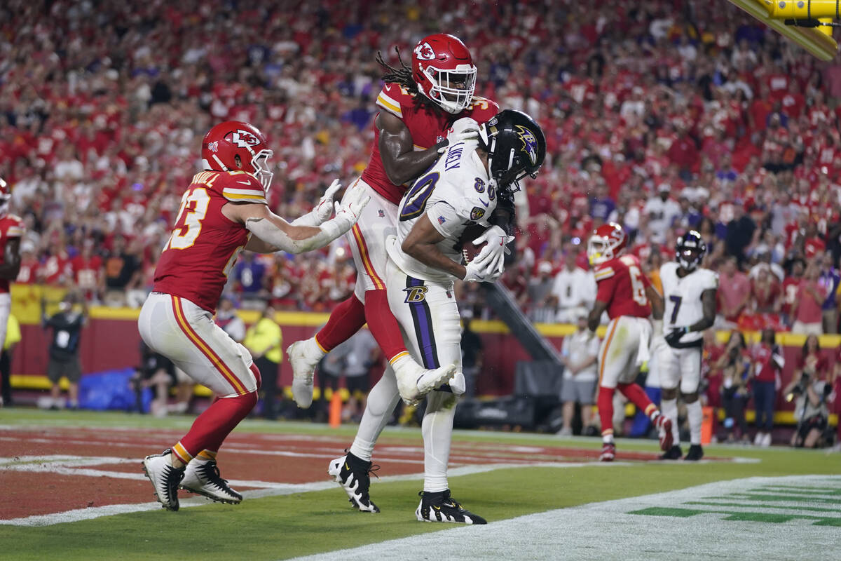 Baltimore Ravens tight end Isaiah Likely (80) catches a pass with his toe out of bounds as Kans ...