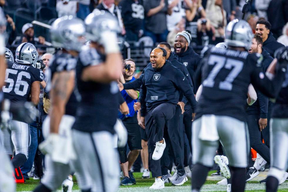 Raiders interim head coach Antonio Pierce and others celebrate a touchdown by defensive tackle ...