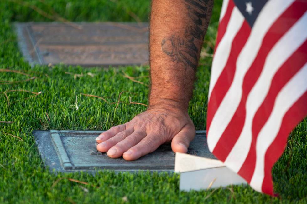 Carlos Gurri cleans the grave of former FBI Special Agent John Bailey at Palm Eastern Mortuary, ...