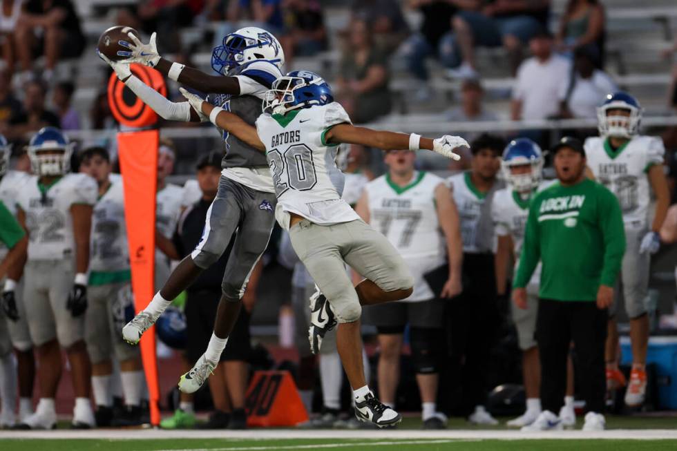 Basic’s Christopher McKenzie, left, catches the ball while Green Valley’s Jerome ...