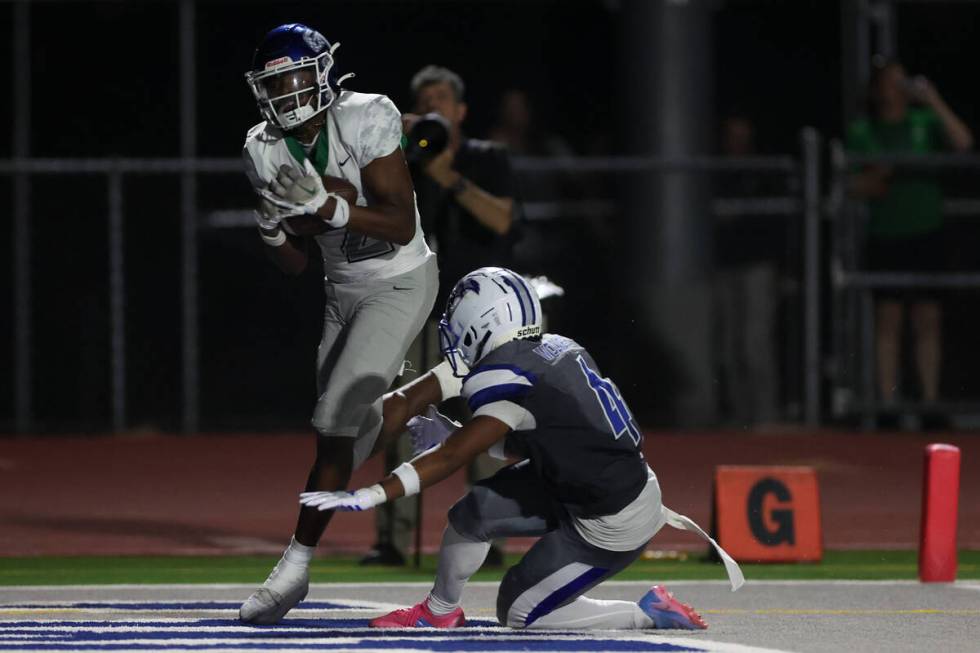 Green Valley’s Evan Williams (2) catches for a touchdown while Basic’s Chris Smit ...