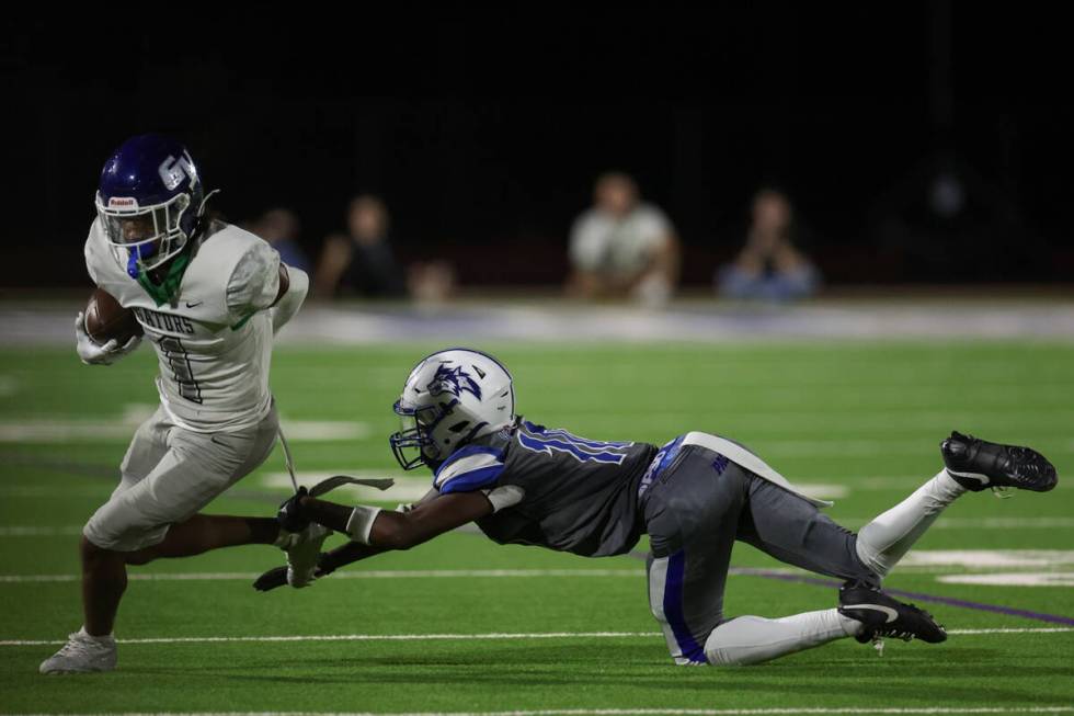 Green Valley wide receiver Trey Glasper (1) evades a tackle by Basic’s Terrion Foster (1 ...