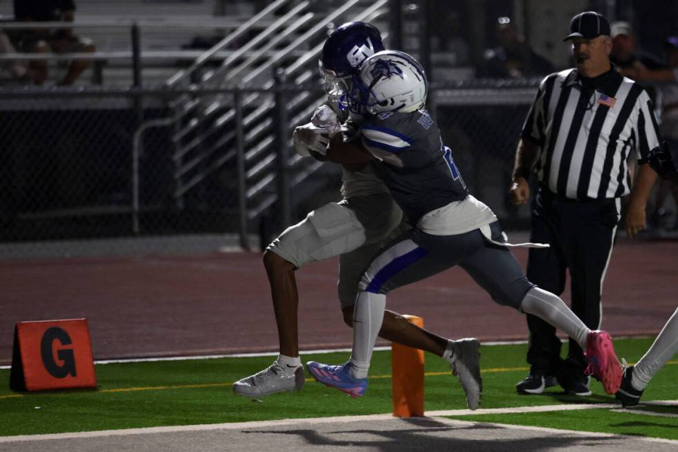 Green Valley wide receiver Trey Glasper scores a touchdown while Basic’s Chris Smith (4) ...