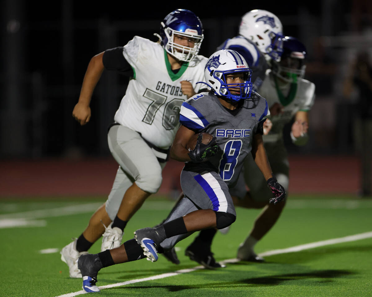 Basic’s Elijah Jones (8) caries the ball up the field during the second half of a high s ...