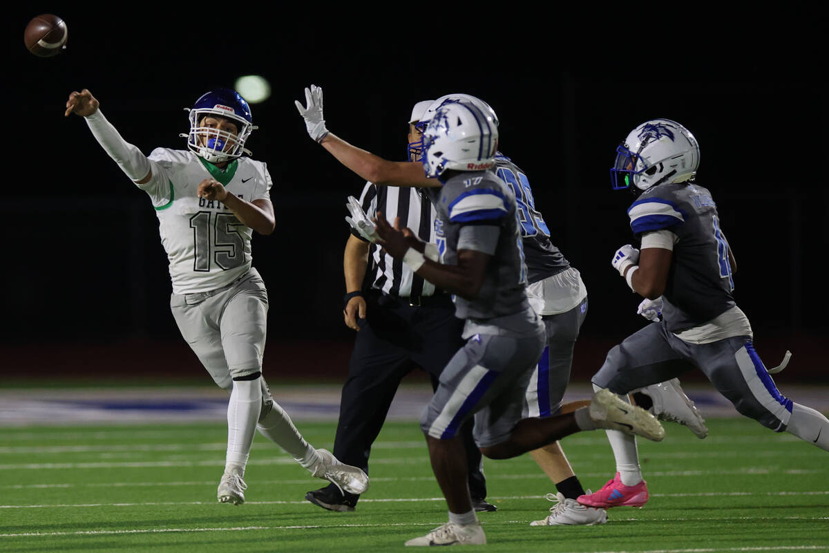 Green Valley quarterback Michael Lewis (15) throws up the field during the second half of a hig ...