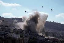 An explosion is seen during an Israeli military operation in the West Bank city of Jenin, Thurs ...