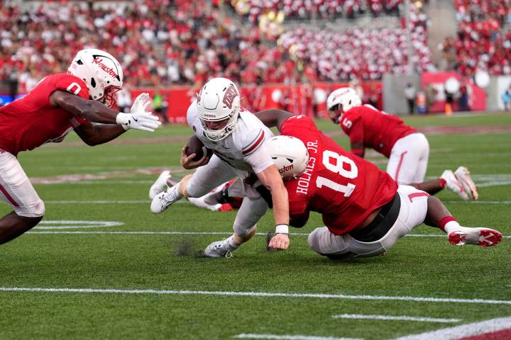 UNLV quarterback Matthew Sluka (3) is stopped short of the goal line by Houston defensive linem ...