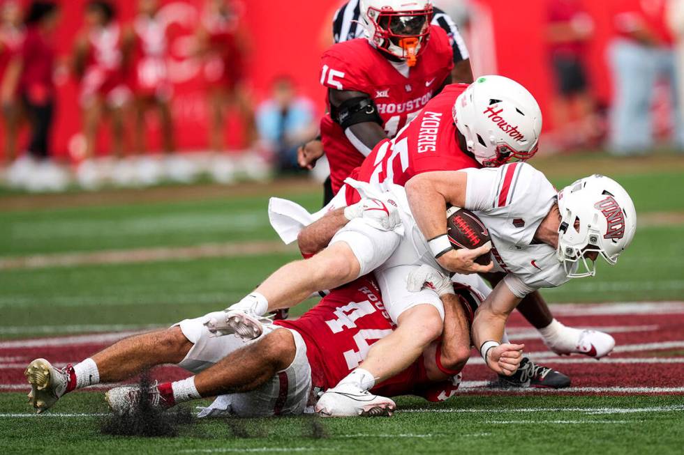 UNLV quarterback Matthew Sluka (3) is stopped after scrambling out of the pocket by Houston lin ...