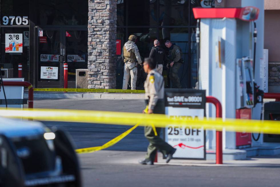 Metro law enforcement stand outside of a Speedway gas station on South Maryland Parkway on Frid ...