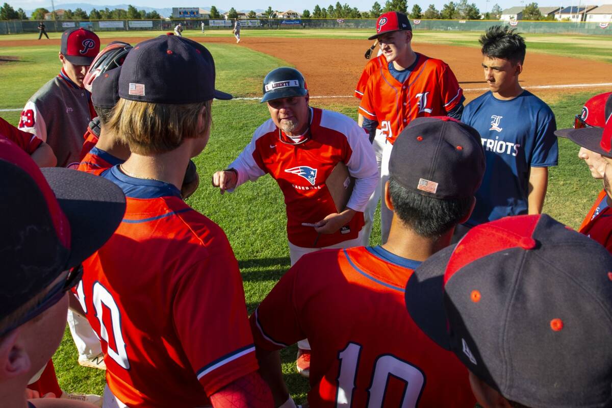 Liberty coach Rich Ebarb motivates his players late in the game during a timeout against Spring ...