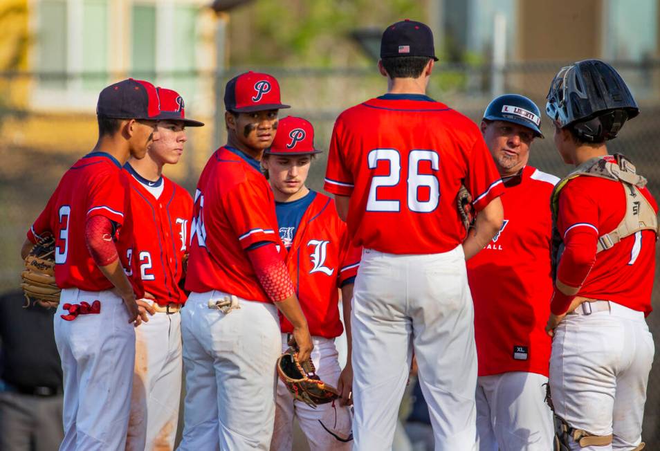 Liberty players come together with coach Rich Ebarb during a timeout against Spring Valley duri ...