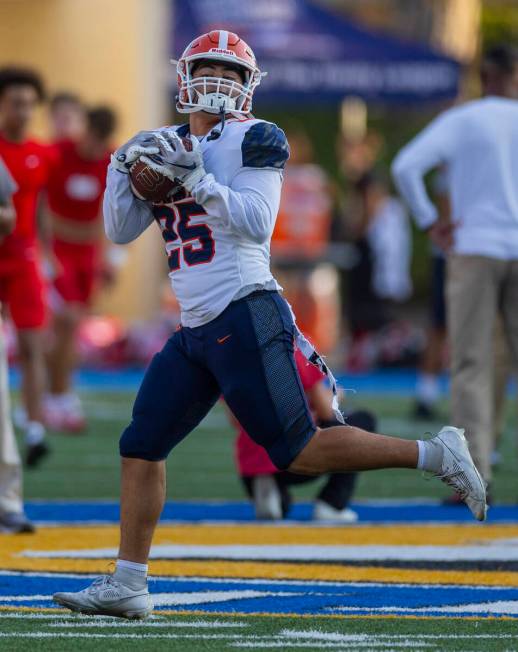 Bishop Gorman running back Danten Kaheaku (25) catches a pass as they warm up to face Mater Dei ...