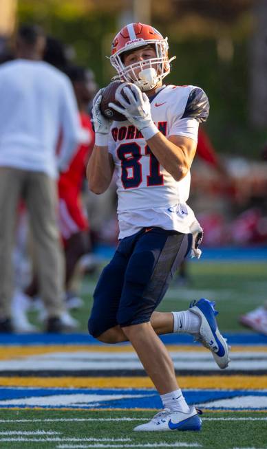 Bishop Gorman wide receiver Gavin Folino (81) catches a pass as they warm up to face Mater Dei ...