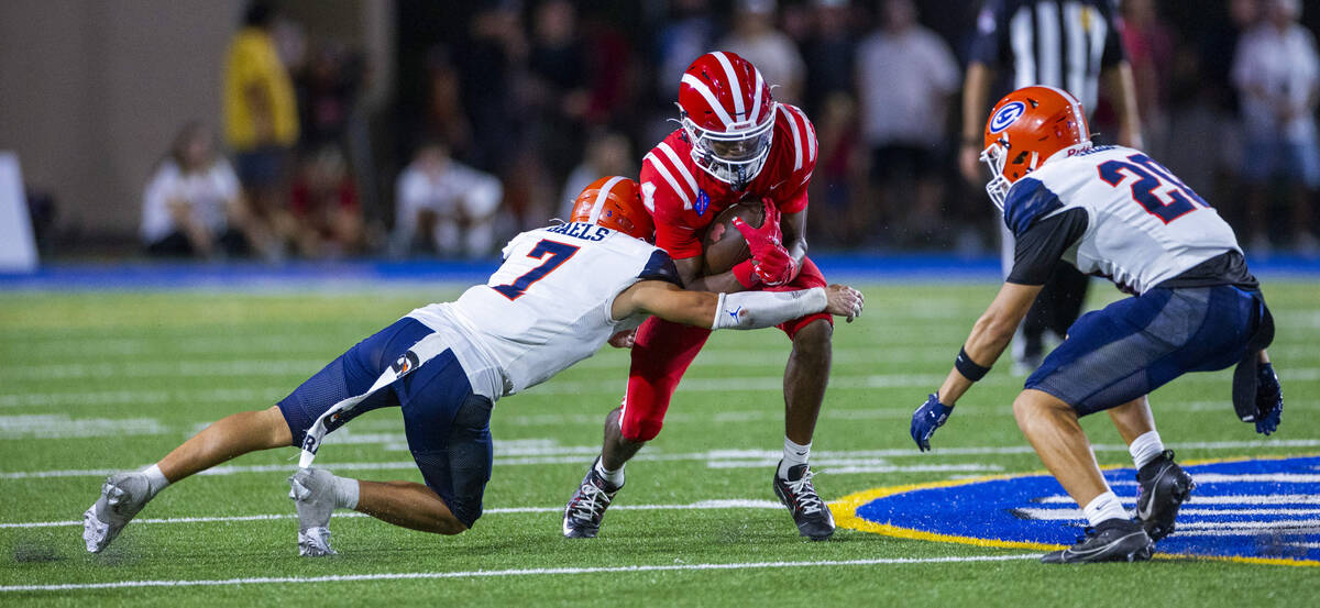 Bishop Gorman defensive back Brayton Correa (7) tackles Mater Dei wide receiver Kayden Dixon-Wy ...