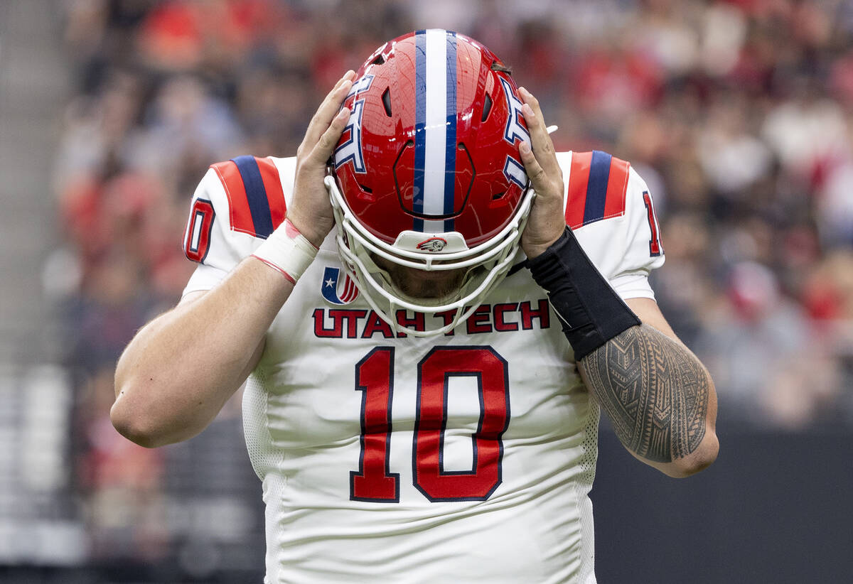 Utah Tech quarterback Deacon Hill (10) grabs his helmet during the college football game agains ...