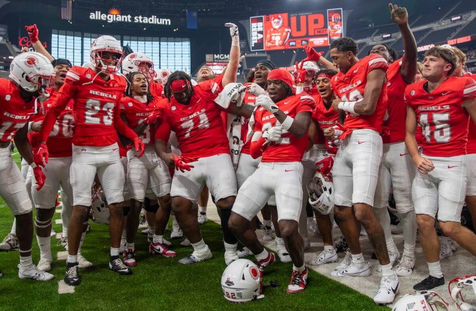 UNLV players celebrate their 72-14 win over Utah Tech with the UNLV Star of Nevada Marching Ban ...